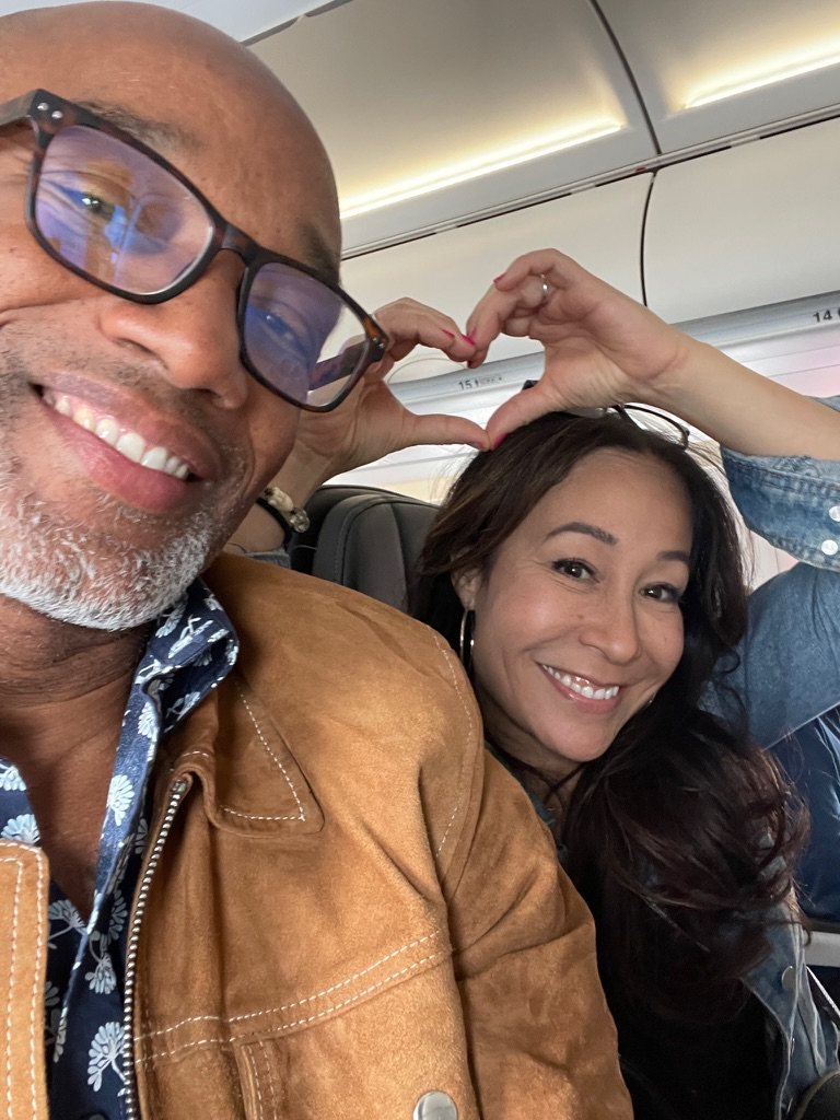 Lisa and Nicolas making a heart on a plane