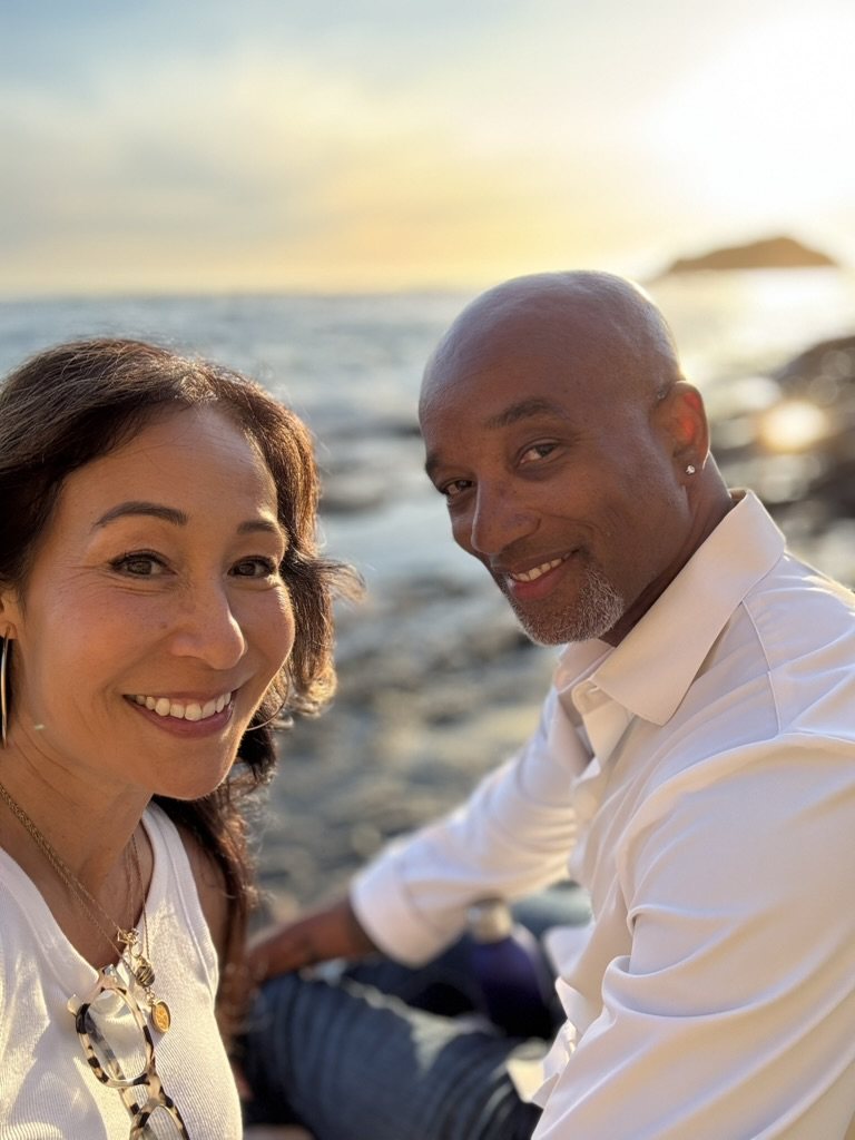 Lisa and Nicolas by the ocean at sunset